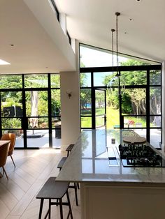 an open kitchen and dining room with large windows