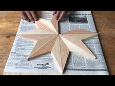 someone is making a wooden star out of wood