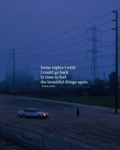 a car driving down a road at night with a person standing in the middle of it