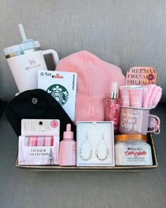 the contents of a woman's purse are displayed in a box on a couch