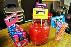 there is a jar with some candy in it on the table next to other items