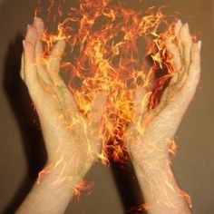 two hands are shown with fire in the middle and on top of them, both holding their hands together