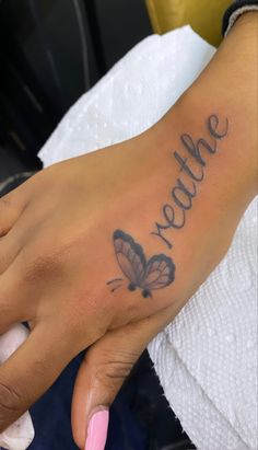 a woman's hand with a butterfly tattoo on it that says, yette me