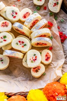 there are many pieces of food on the table with flowers in the backgroud