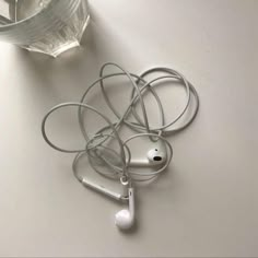 an apple headphones are sitting next to a water bottle