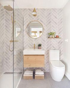 a bathroom with a toilet, sink and mirror