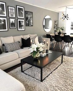 a living room filled with furniture and pictures on the wall above it's coffee table