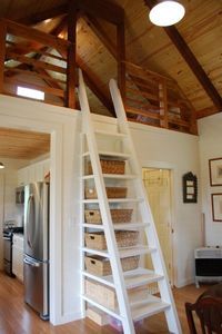 there is a ladder in the middle of this room that leads up to the loft