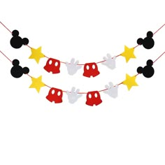 mickey mouse party decorations with yellow stars and red minnie mouse heads on the bunting