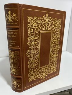 two brown books sitting on top of a white table