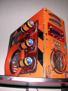 an orange computer case sitting on top of a shelf