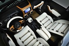 the interior of a car with white and tan leather seats