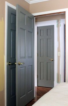 two gray doors are open in a bedroom