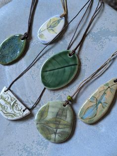 Choose from 6 one-of-a-kind pendants, handmade from strong and lightweight stoneware clays. This pendant style has been bisque and glaze fired for strength. Hangs on a black or brown waxed cotton cord as shown, with slide knots to adjust length. Clay is a natural product and holds warmth, so it feels lovely to wear against the skin. Each tabbie stone pendant is the result of a combination of traditional and experimental techniques. ----------- Diffuser pendants:  The listing video shows how how Air Dry Clay Pendants, Clay Necklace Ideas, Ceramic Pendants, Ceramic Jewellery, Clay Pendants, Oil Diffuser Necklace, Essential Oil Blends Recipes, Jewellery Unique, Clay Jewellery