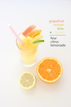 an orange and lemon drink with grapefruit on the side