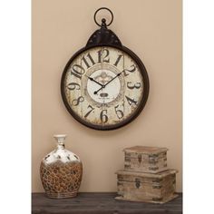 a clock on the wall next to two vases and an old box sitting on a shelf