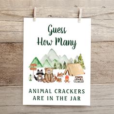 an animal crackers are in the jar sign on a wooden background with clothes pins