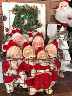 a basket filled with santa claus figurines sitting on top of a table