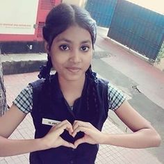 a girl making a heart with her hands