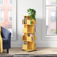 a living room with a blue chair and a yellow book shelf next to a window