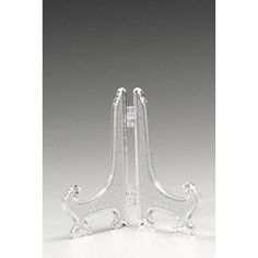 a clear glass candle holder with two candles on each side and an acrylic base