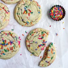 several cookies with sprinkles are on the table