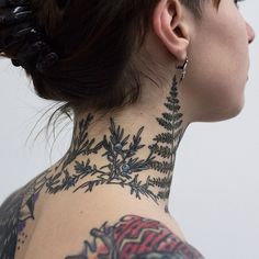 a woman with tattoos on her neck and back