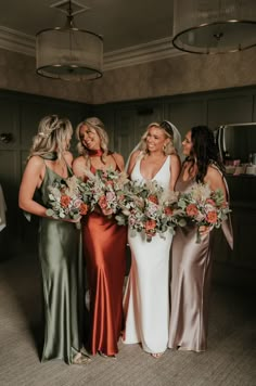 the bridesmaids are holding their bouquets and smiling at each other in this photo