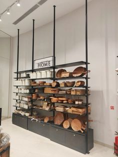 the shelves are filled with various types of wooden utensils and other kitchen items