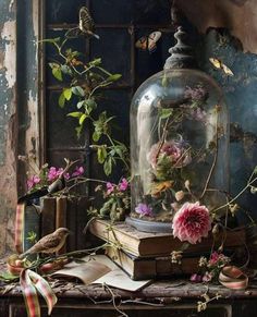 an old book with flowers and birds under a glass dome