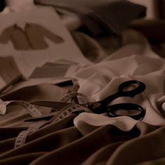 black and white photograph of scissors on fabric