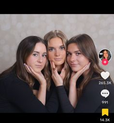 three women are posing for the camera with their hands on their cheeks and one is holding her face