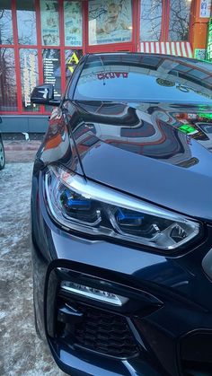 the front end of a car parked in front of a building