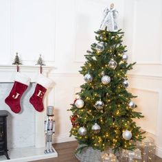 a christmas tree with stockings hanging from it