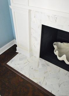 a white fireplace with a bowl on the mantle