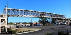 a bridge over a street with cars driving under it