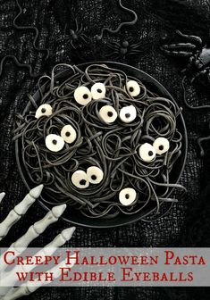 creepy halloween pasta with edible eyeballs and fake teeth on black cloth, with text that reads creepy halloween pasta with edible eyeballs