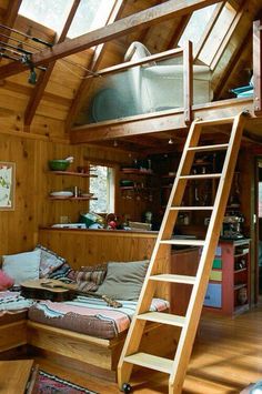 a loft bed with a ladder to the top and stairs leading up to it's second floor