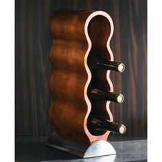 a wooden wine rack with three bottles in it