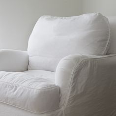 a white couch sitting next to a window