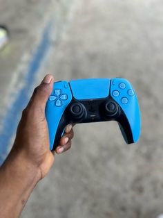 a person holding a blue controller in their hand