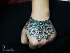 a person's hand with a tattoo design on the top and bottom of it