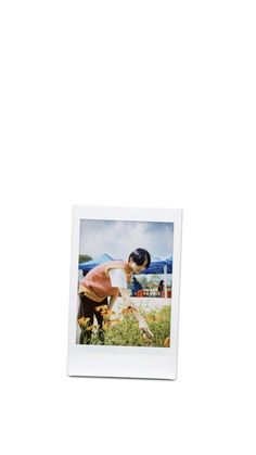 a polaroid photograph of two people in the grass