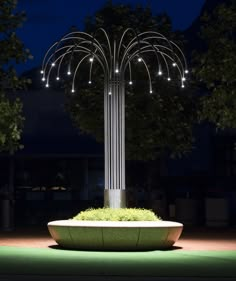 a planter is lit up at night with lights on the top and around it