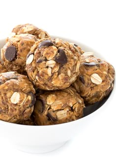 a white bowl filled with chocolate chip cookies and oatmeal bites on top of each other