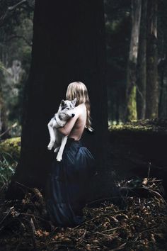 a woman holding a dog in her arms with the words fairy dust over her shoulder