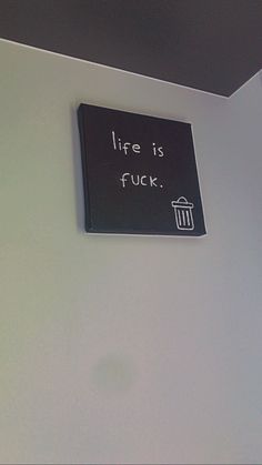 there is a sign on the wall that says, life is f kk '