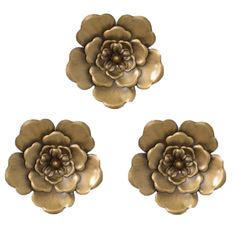 three metal flowers are shown on a white background, one is gold and the other is brown