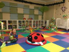 the children's play area is brightly colored and has toys for them to sit on