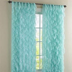 the curtains are hanging in front of a window with blue ruffles on it